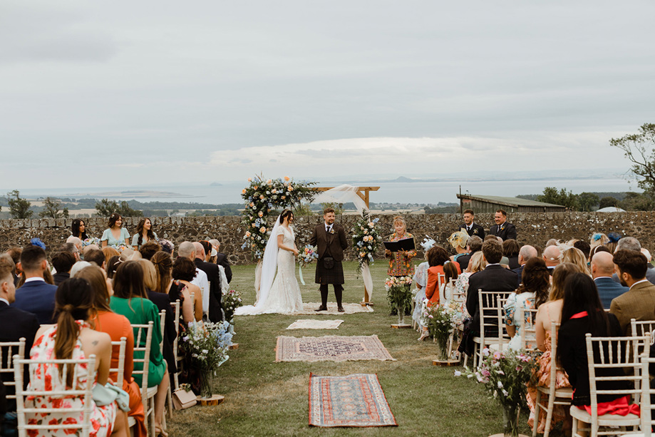 Outdoor ceremony with bride and groom at altar